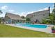Backyard pool featuring an diving board, spacious patio with outdoor seating, and manicured lawn at 2256 Drawbridge Ct, Rock Hill, SC 29732