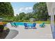 Backyard pool area surrounded by blue chairs and lush green trees at 2256 Drawbridge Ct, Rock Hill, SC 29732