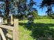 Backyard with wooden swing set and partially fenced yard at 22987 Alonzo Rd, Oakboro, NC 28129