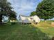 Home featuring a backyard with a deck and ample green space, shaded by mature trees at 22987 Alonzo Rd, Oakboro, NC 28129