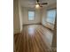 This cozy bedroom features a ceiling fan and natural light from two windows at 22987 Alonzo Rd, Oakboro, NC 28129