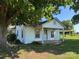 Exterior front view of a cozy home featuring a covered porch and a convenient carport at 22987 Alonzo Rd, Oakboro, NC 28129