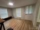 Living room with natural light, wood-look floors, and built-in bench at 22987 Alonzo Rd, Oakboro, NC 28129