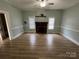 Open living room with many windows and a fireplace at 22987 Alonzo Rd, Oakboro, NC 28129