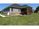 Backyard featuring a well-maintained lawn, covered patio, and side-entry garage at 231 Glenwood Dr # 4, Oakboro, NC 28129