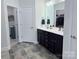 Bathroom featuring dual vanity with granite counters, dark cabinetry, and tiled floors at 231 Glenwood Dr # 4, Oakboro, NC 28129