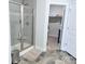 Modern bathroom featuring tiled shower, glass door, tiled floors, and access to a walk-in closet at 231 Glenwood Dr # 4, Oakboro, NC 28129