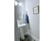 Powder room with pedestal sink, modern faucet, decorative mirror, and neutral walls at 231 Glenwood Dr # 4, Oakboro, NC 28129