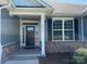 Inviting front entrance featuring a black door, sidelights, and elegant stone accents for added curb appeal at 231 Glenwood Dr # 4, Oakboro, NC 28129