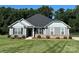 Charming single-story home with gray siding, black shutters, stone accents, and a well-manicured lawn at 231 Glenwood Dr # 4, Oakboro, NC 28129