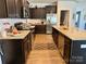 Galley kitchen boasting granite countertops, wood cabinetry, and stainless steel appliances at 231 Glenwood Dr # 4, Oakboro, NC 28129