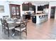 Open-concept kitchen and dining area with wood floors, dark cabinets, and a granite island at 231 Glenwood Dr # 4, Oakboro, NC 28129
