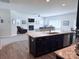 Open-concept kitchen leading to a living room with fireplace, offers modern living and entertaining space at 231 Glenwood Dr # 4, Oakboro, NC 28129