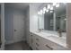 Bright bathroom features a double vanity, storage cabinets, sleek lighting, and a glass-enclosed shower at 2410 Monticello Dr, Gastonia, NC 28056