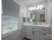 Bright bathroom with modern vanity, stylish fixtures, and ample natural light from the large window at 2410 Monticello Dr, Gastonia, NC 28056