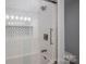 Modern bathroom with tub and shower, stylish tile accents, and glass door at 2410 Monticello Dr, Gastonia, NC 28056