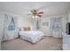 Comfortable bedroom with ample natural light, a ceiling fan, and a queen-sized bed with neutral accents at 2410 Monticello Dr, Gastonia, NC 28056