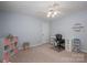 Light blue bedroom with a ceiling fan, closet, built in desk and a pink organization system at 2410 Monticello Dr, Gastonia, NC 28056