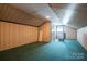 Finished attic space offers ample room with wood paneled walls and blue carpet at 2410 Monticello Dr, Gastonia, NC 28056