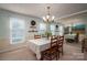 Elegant dining room features a chandelier, large mirror, and table set for four with decorative wainscotting at 2410 Monticello Dr, Gastonia, NC 28056