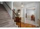 Traditional foyer with a carpeted staircase, wooden banister, hardwood floors, and an arched entry into another room at 2410 Monticello Dr, Gastonia, NC 28056