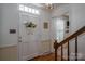 Traditional foyer featuring a hardwood floor, wooden staircase, paneled walls, and a classic white entry door at 2410 Monticello Dr, Gastonia, NC 28056