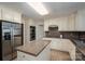 Well-lit kitchen features stainless steel appliances, custom cabinets, and a center island with granite countertops at 2410 Monticello Dr, Gastonia, NC 28056