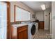 Spacious laundry room featuring modern washer and dryer, utility sink, and ample counter space at 2410 Monticello Dr, Gastonia, NC 28056
