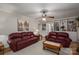 Spacious living room features hardwood floors, bookshelves, crown molding, and two maroon couches at 2410 Monticello Dr, Gastonia, NC 28056