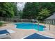 A backyard pool features a pristine diving board and steps for easily getting in and out at 2410 Monticello Dr, Gastonia, NC 28056