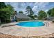Relaxing backyard pool featuring a diving board, ladder, and stone detailing at 2410 Monticello Dr, Gastonia, NC 28056