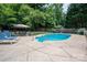 Backyard pool featuring lounge chairs, a diving board, a gazebo with a table and chairs, and a sturdy safety fence at 2410 Monticello Dr, Gastonia, NC 28056