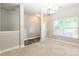 Spacious room with neutral walls, a window for natural light, and elegant chandelier at 2476 Glyncastle Way, Gastonia, NC 28056