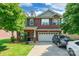 Charming two-story brick home featuring a well-manicured lawn and an attached two-car garage at 2476 Glyncastle Way, Gastonia, NC 28056