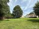 Expansive backyard with lush greenery, privacy fence, and mature trees at 2511 Old Pond Dr, Lincolnton, NC 28092