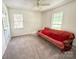 Bright bedroom featuring two windows and a comfortable red futon at 2511 Old Pond Dr, Lincolnton, NC 28092