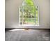 Bright bedroom featuring a large window with views of the landscaped surroundings at 2511 Old Pond Dr, Lincolnton, NC 28092