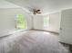Spacious primary bedroom with vaulted ceilings, ceiling fan, and large windows providing ample natural light at 2511 Old Pond Dr, Lincolnton, NC 28092