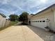 Long driveway leading to an attached garage, surrounded by manicured landscaping at 2511 Old Pond Dr, Lincolnton, NC 28092