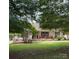 Charming single-story home featuring a welcoming front porch and lush green lawn at 2511 Old Pond Dr, Lincolnton, NC 28092