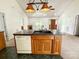 A kitchen island with wood cabinets and a black countertop is connected to the living room area at 2511 Old Pond Dr, Lincolnton, NC 28092