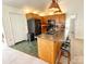 The kitchen boasts an island with seating, blending into a space with modern appliances and green tile flooring at 2511 Old Pond Dr, Lincolnton, NC 28092