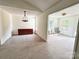 Bright living room showcasing a sideboard cabinet and a glimpse into a sunlit sitting area with outdoor access at 2511 Old Pond Dr, Lincolnton, NC 28092