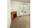 Cozy living area featuring a corner fireplace and a window overlooking an outdoor seating area at 2511 Old Pond Dr, Lincolnton, NC 28092