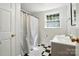 Well-lit bathroom featuring a walk-in shower and vanity at 307 Dogwood Dr, Mount Holly, NC 28120