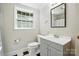 Bright bathroom with a walk-in shower and vanity at 307 Dogwood Dr, Mount Holly, NC 28120