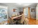Dining room with an oval table, six chairs, area rug, and a view to the kitchen at 307 Dogwood Dr, Mount Holly, NC 28120