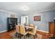 Dining room with an oval table, six chairs, area rug, chandelier, and pictures on the walls at 307 Dogwood Dr, Mount Holly, NC 28120