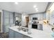 Kitchen with gray cabinets, stainless steel appliances, large sink and brick floors at 307 Dogwood Dr, Mount Holly, NC 28120