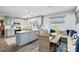 Eat-in kitchen with gray cabinets, brick floor, stainless steel appliances, and seating at 307 Dogwood Dr, Mount Holly, NC 28120